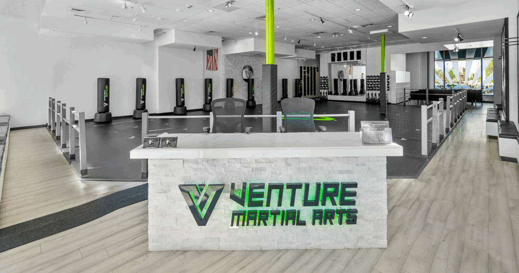 Reception area of Venture Martial Arts with a modern design and logo prominently displayed.