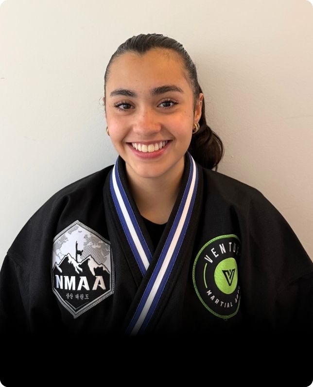 Smiling martial artist showcasing skills and confidence in training.